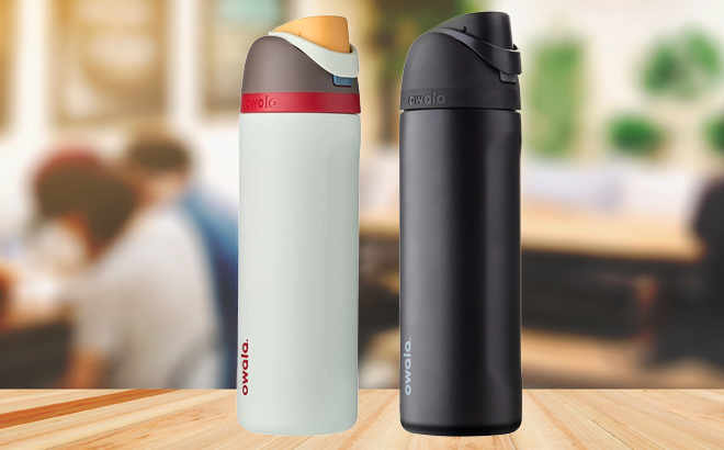 Two Colors of Owala FreeSip Insulated Stainless Steel Water Bottle 24 Ounce on a Wooden Table