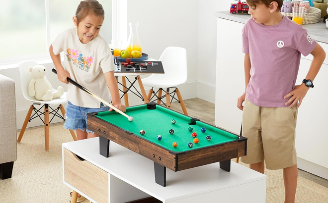 Two kids playing pool on BCP 11 in 1 Combo Game Table Set