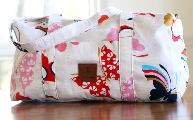 Vera Bradley New Hope Girls Medium Duffel Bag on a Table Vera Bradley New Hope Girls Medium Duffel Bag on a Table