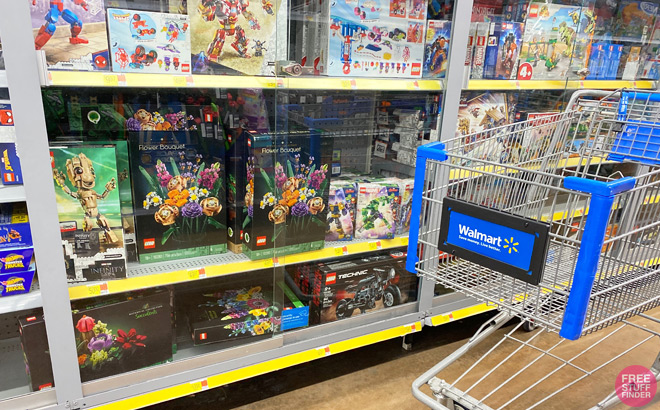 Walmart Shopping Cart in front of Lego Sets on a Shelf