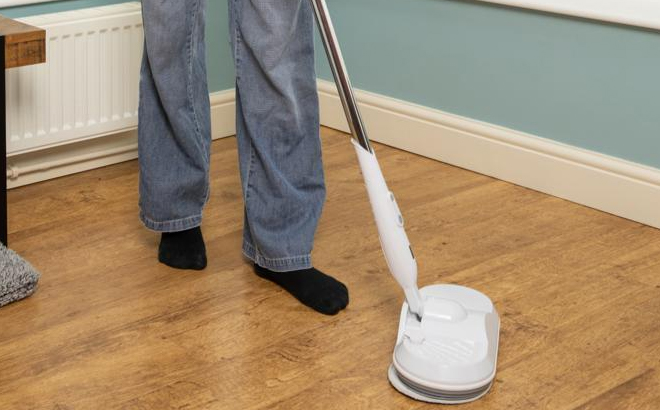 Woman Cleaning Hard Wood Floors with Ewbank Electra-1 Cordless Polisher and Washer Woman Cleaning Hard Wood Floors with Ewbank Electra-1 Cordless Polisher and Washer