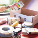 Woman Filling Her iMemories SafeShip Kit with Old Family Videos and Photos
