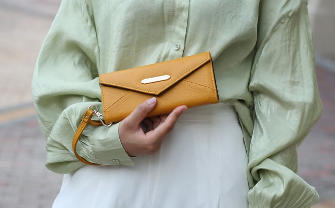 Woman Holding MKF Christine Vegan Leather Wallet Woman Holding MKF Christine Vegan Leather Wallet