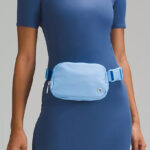Woman Wearing the Lululemon Everywhere Belt Bag in Aero Blue Color