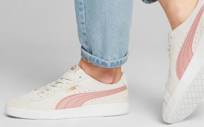 Woman Wearing the Vikky V3 Womens Sneakers in Vapor Gray Future Pink PUMA Gold PUMA White