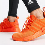 Woman is Wearing Adidas NMD Shoes in Impact Orange Color