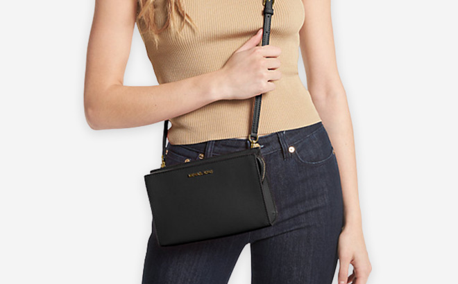 Woman is Wearing Michael Kors Sheila Small Faux Saffiano Leather Crossbody Bag in Black Color