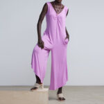 Woman is Wearing NYCo Beaded Halter Neck Jumpsuit in Violet Naples Color