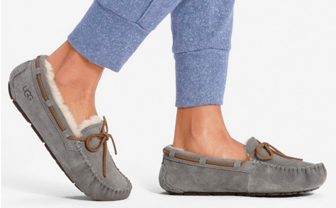 Woman is Wearing a UGG Womens Dakota Suede Moccasin Slippers in Pewter Color