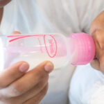 an Image of a Baby Drinking from a Baby Bottle
