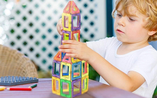 an Image of a Boy Playing with a Magnetic STEM Building Blocks an Image of a Boy Playing with a Magnetic STEM Building Blocks