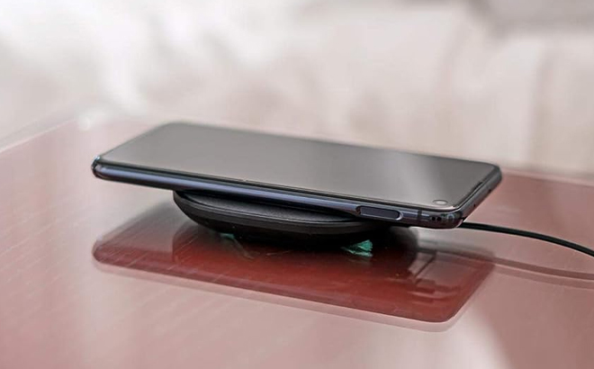 mophie Wireless 10W Charging Pad Charging a Phone on a Table