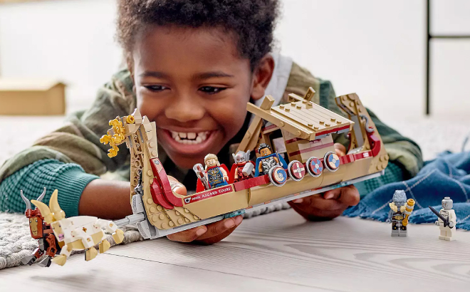 A Boy Playing with LEGO Marvel Thor The Goat Boat Building Set