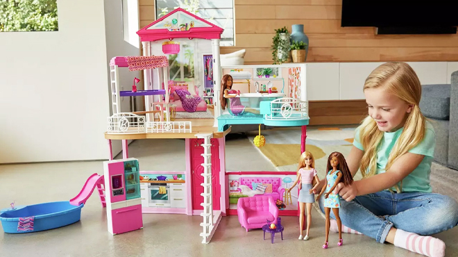 A Girl Playing with Barbie Dollhouse Set