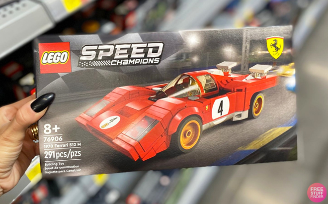 A Hand Holding LEGO Speed Champions Ferrari Set