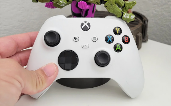 A Hand Holding Microsoft Xbox Wireless Controller in Robot White Color