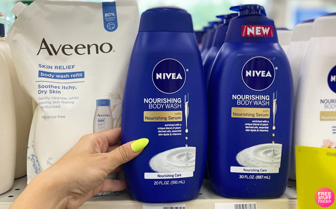 A Hand Holding Nivea Nourishing Botanical Blossom Body Wash on a Shelf