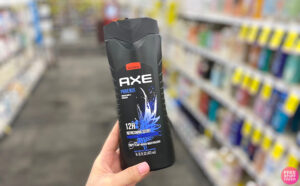 A Hand Holding a Axe Mens Body Wash on CVS Aisle