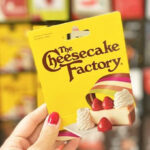 A Hand Holding a Cheesecale Factory Gift Card