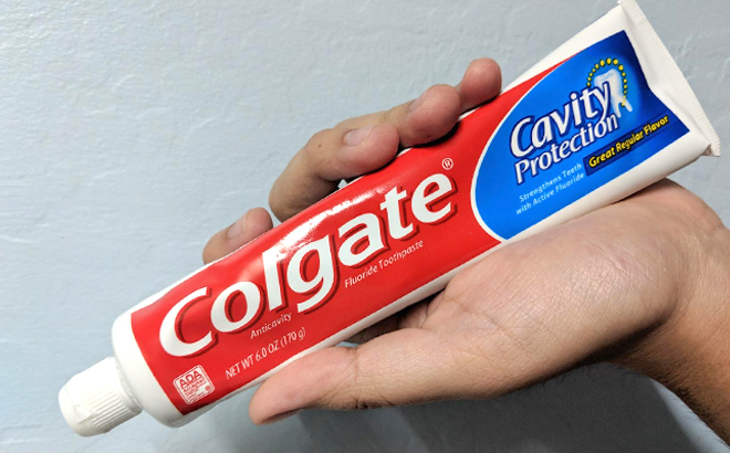 A Hand Holding a Colgate Cavity Protection Toothpaste