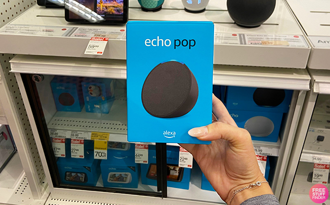 A Hand Holding the Echo Pop Smart Speaker