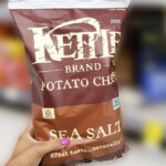 A Person Holding Kettle Brand Sea Salt Potato Chips