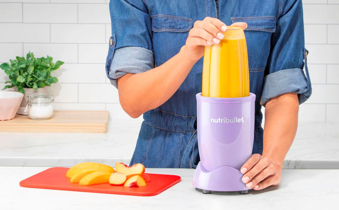 A Person Using Purple NutriBullet in a Kitchen