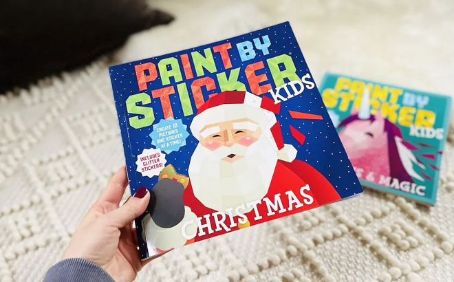 A Person holding a Paint by Sticker Kids Christmas