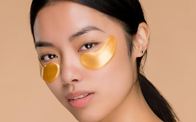 A Woman Using a Dermora Golden Glow Under Eye Patch