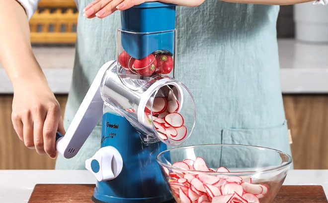 A Woman is Slicing a Strawberry Using a Geedel Rotary Cheese Grater A Woman is Slicing a Strawberry Using a Geedel Rotary Cheese Grater