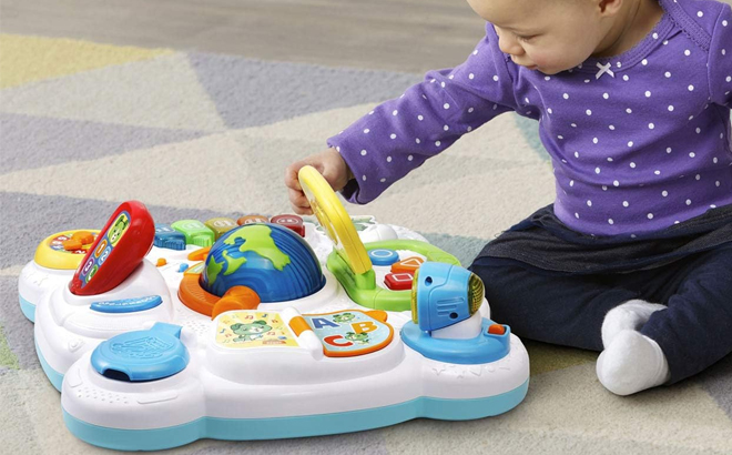 A toddler playing with the LeapFrog Little Office Learning Center