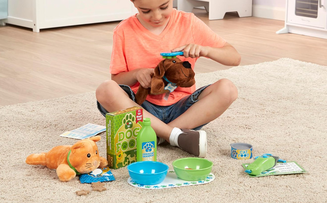 Boy is Playing with Melissa Doug Feeding and Grooming Pet Care Play Set