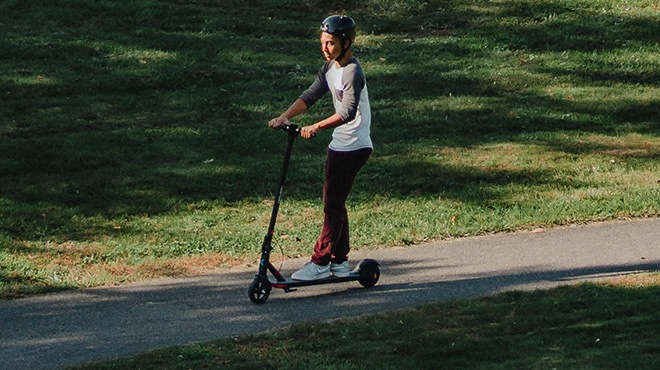 Boy riding on a Hover 1 Highlander Foldable Electric Scooter