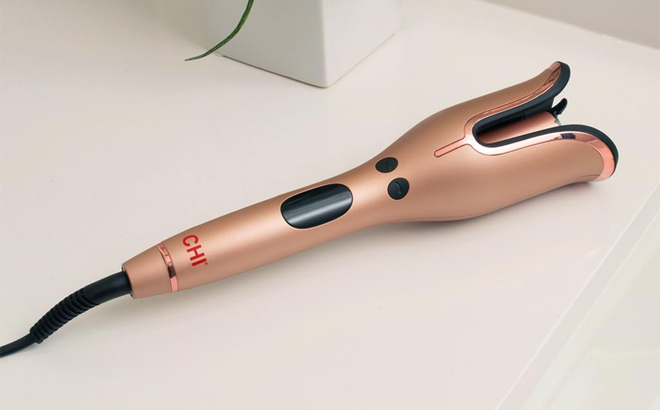 CHI Spin N Curl Special Edition Rose Gold Hair Curler on a Bathroom Counter