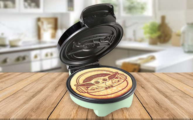 Disney Collection The Child Mini Waffle Maker on a Kitchen Table