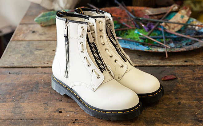 Dr Martens Womens 1460 Twin Zip Fashion Boot in White Sendal on a Table