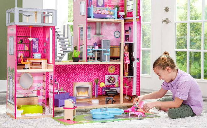 Girl Playing With KidKraft Wooden Dollhouse