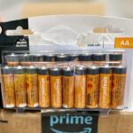 Hand Holding Amazon Basics Alakaline Batteries