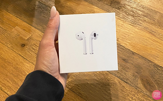 Hand Holding Apple AirPods in a Box