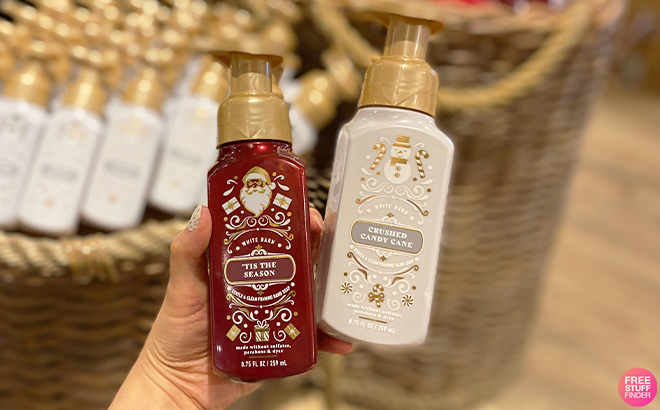 Hand Holding Bath Body Works Tis The Season and Crushed Candy Cane Hand Soaps