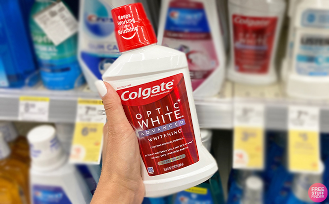 Hand Holding Colgate Optic White Mouthwash at Walgreens