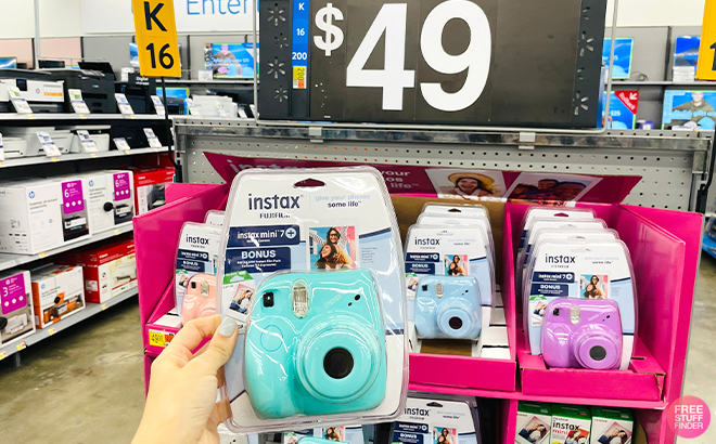 Hand Holding Fujifilm Instax Mini 7+ Exclusive Blister Bundle in Blue Color