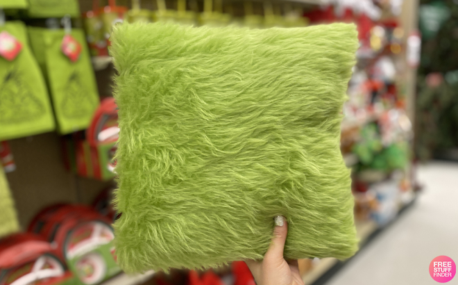 Hand Holding Furry Green Grinch Pillow