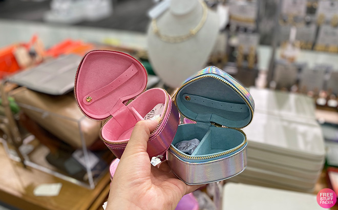Hand Holding Jewelry Boxes in a Store
