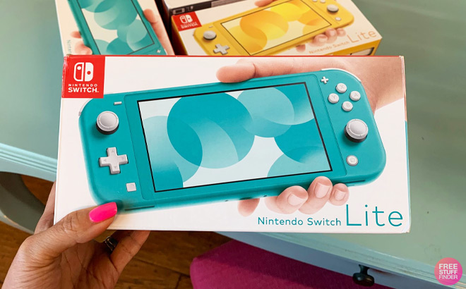 Hand Holding Nintendo Switch Lite in Turquoise Color