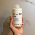 Hand Holding Olaplex No 4 Bond Maintenance Shampoo