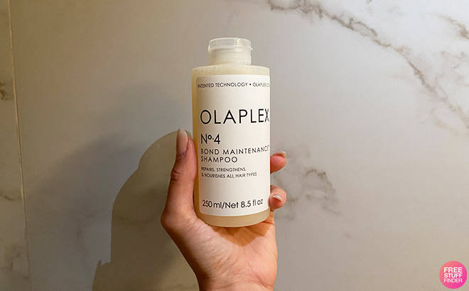 Hand Holding Olaplex No 4 Bond Maintenance Shampoo