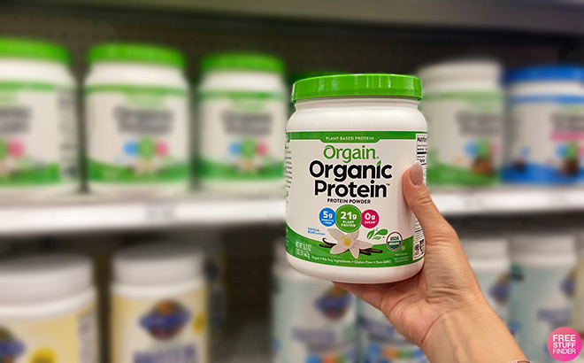 Hand Holding Orgain Organic Vegan Protein Powder Vanilla Bean