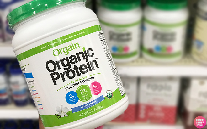 Hand Holding Orgain Organic Vegan Protein Powder in Vanilla Bean Flavor