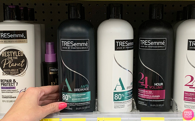 Hand Holding TRESemme Shampoo and Conditioner in a Store Aisle